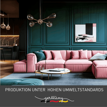 Modern living room with pink sofa and green wall, showcasing stylish interior design, made in Germany under high environmental standards.